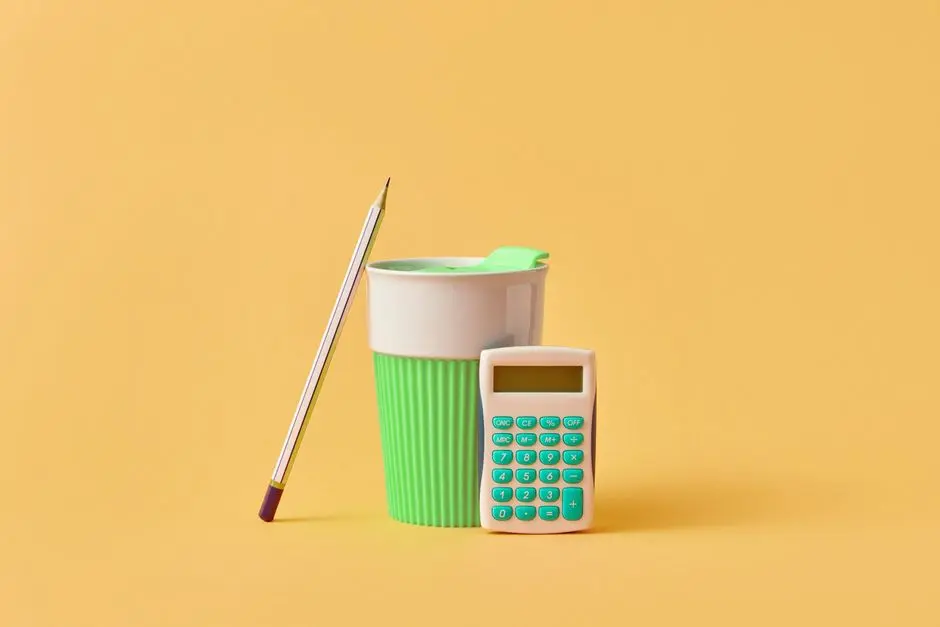 Minimalist desk setup with a pencil, green cup, and calculator on yellow background.